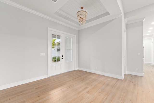 entrance foyer featuring a tray ceiling, crown molding, light wood-style flooring, and baseboards