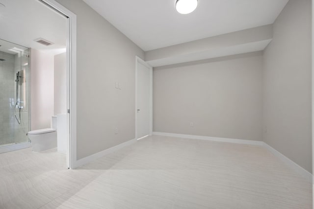 unfurnished room with visible vents and baseboards