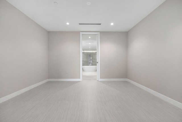 unfurnished room featuring recessed lighting, visible vents, and baseboards