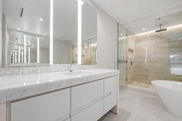 full bathroom with recessed lighting, vanity, visible vents, a soaking tub, and a marble finish shower