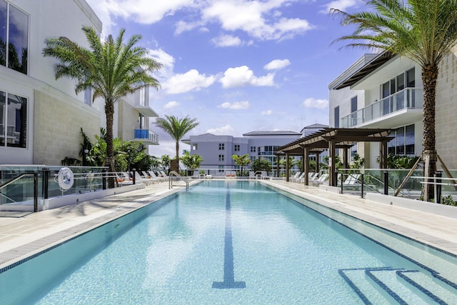 pool with a patio and a pergola