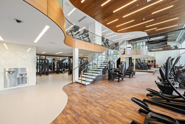 exercise room featuring wood finished floors and visible vents