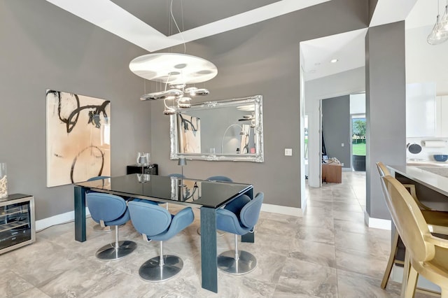 dining area featuring beverage cooler and baseboards