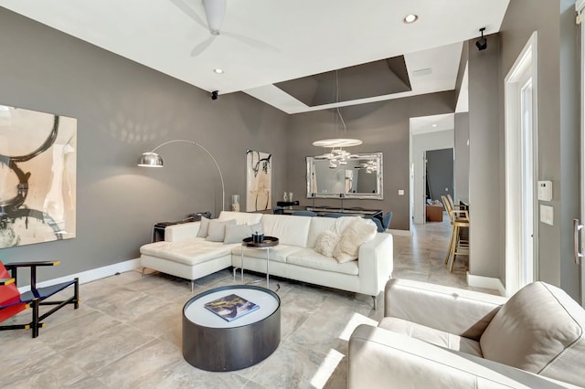 living room featuring a high ceiling, baseboards, a ceiling fan, and recessed lighting