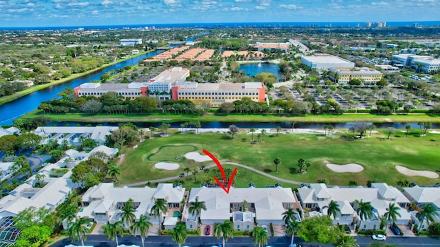 drone / aerial view featuring a residential view, a water view, and golf course view