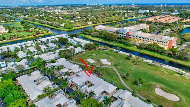 birds eye view of property with view of golf course, a water view, and a residential view