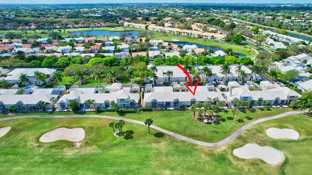 drone / aerial view featuring a residential view, a water view, and golf course view