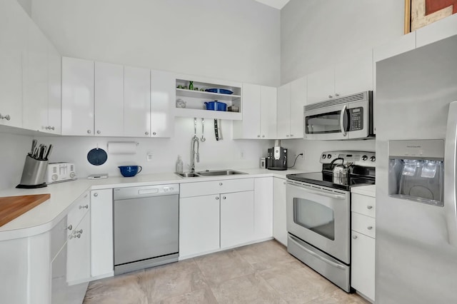 kitchen with white cabinetry, stainless steel appliances, and a sink