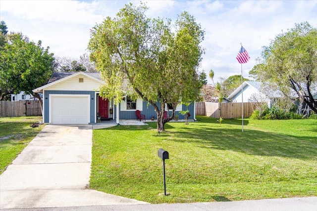 view of front of property with concrete driveway, an attached garage, fence, and a front yard