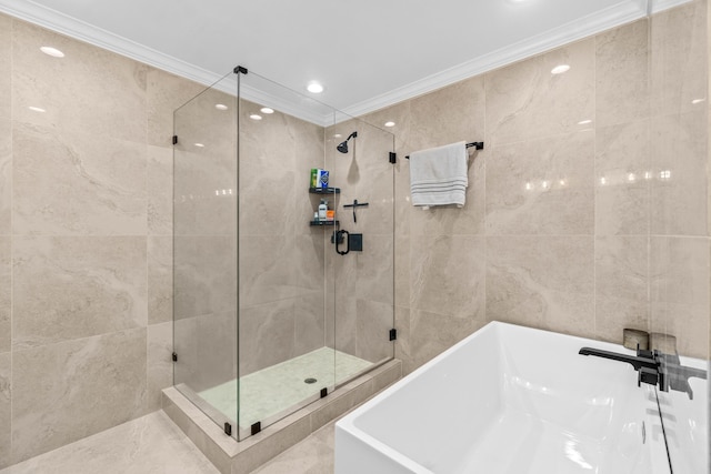 bathroom with a stall shower, a freestanding tub, tile walls, and crown molding