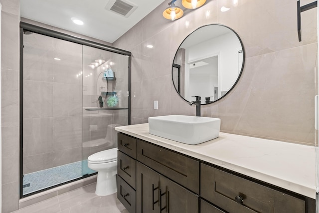 full bathroom featuring visible vents, toilet, tile walls, and a shower stall