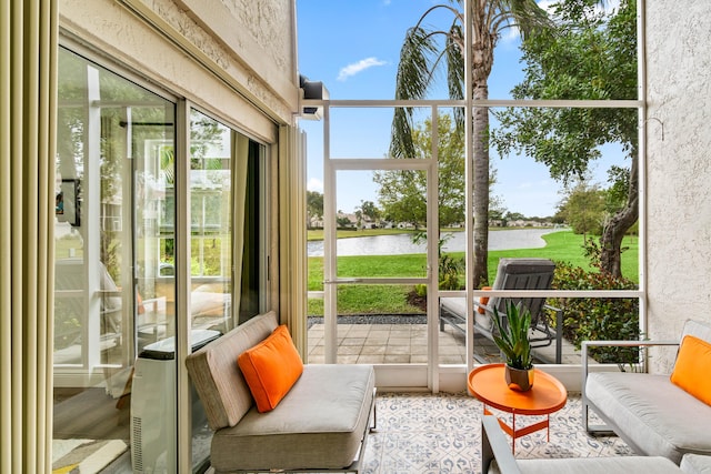 sunroom / solarium featuring a water view