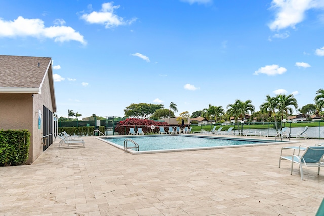 pool featuring a patio area and fence