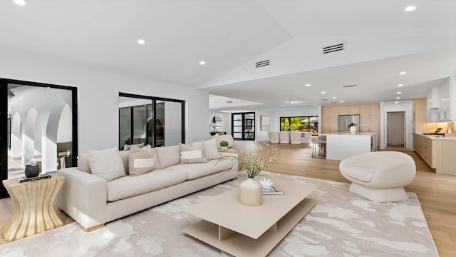 living area featuring recessed lighting, visible vents, and light wood finished floors