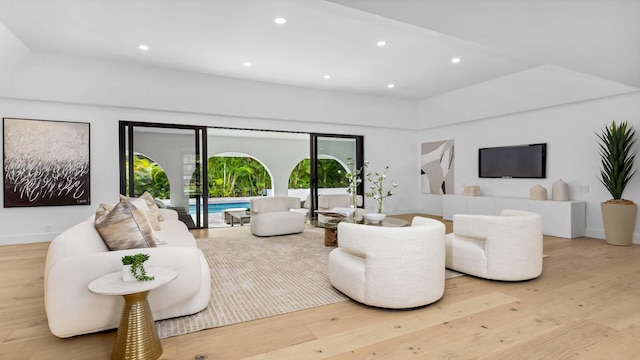 living area with light wood finished floors, baseboards, and recessed lighting