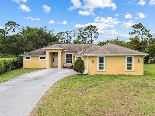 ranch-style home with driveway, roof with shingles, a front yard, and stucco siding