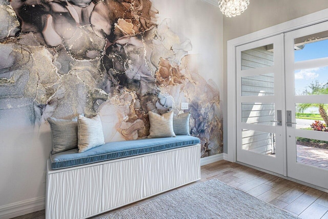 entryway featuring an inviting chandelier, baseboards, wood finished floors, and french doors