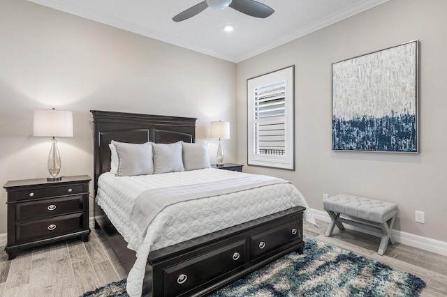 bedroom with ornamental molding, light wood-type flooring, a ceiling fan, and baseboards