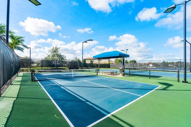 view of tennis court with fence