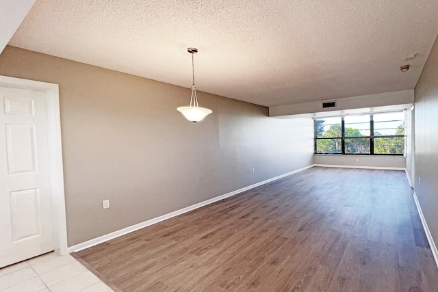3636 Whitehall Dr Unit 402A, West Palm Beach, FL 33401 - empty room with a textured ceiling, wood finished floors, and baseboards