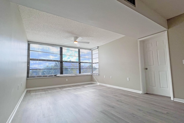 3636 Whitehall Dr Unit 402A, West Palm Beach, FL 33401 - unfurnished room with ceiling fan, wood finished floors, baseboards, and a textured ceiling