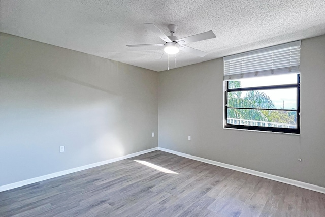 3636 Whitehall Dr Unit 402A, West Palm Beach, FL 33401 - spare room featuring wood finished floors, a ceiling fan, baseboards, and a textured ceiling
