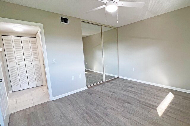 3636 Whitehall Dr Unit 402A, West Palm Beach, FL 33401 - unfurnished bedroom with wood finished floors, baseboards, and ceiling fan
