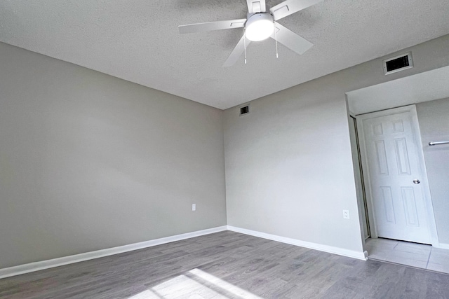 3636 Whitehall Dr Unit 402A, West Palm Beach, FL 33401 - unfurnished room featuring wood finished floors, ceiling fan, a textured ceiling, and baseboards