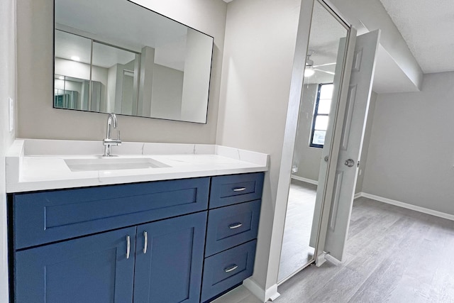 3636 Whitehall Dr Unit 402A, West Palm Beach, FL 33401 - full bath featuring wood finished floors, vanity, baseboards, and ceiling fan