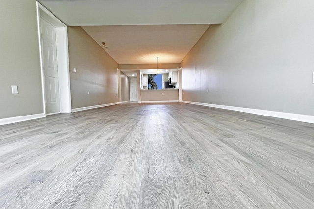 3636 Whitehall Dr Unit 402A, West Palm Beach, FL 33401 - unfurnished living room with wood finished floors and baseboards