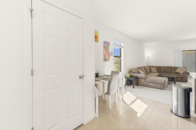 living area with light colored carpet and light tile patterned flooring