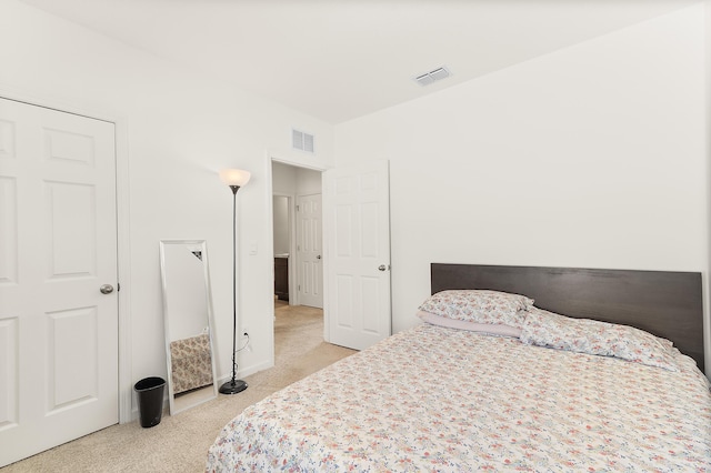 bedroom featuring light colored carpet and visible vents