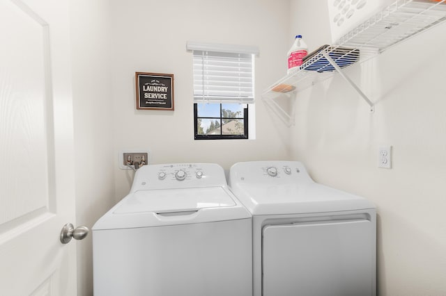 washroom featuring laundry area and washing machine and dryer