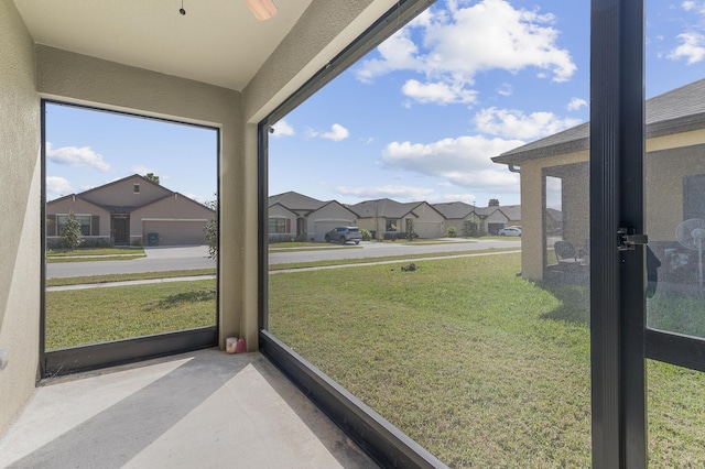 sunroom featuring a residential view