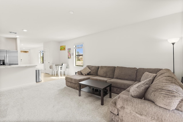 living room featuring light carpet, visible vents, and recessed lighting