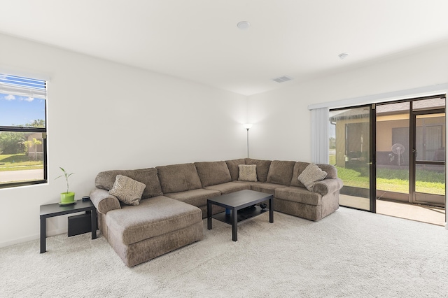 carpeted living area with visible vents and baseboards