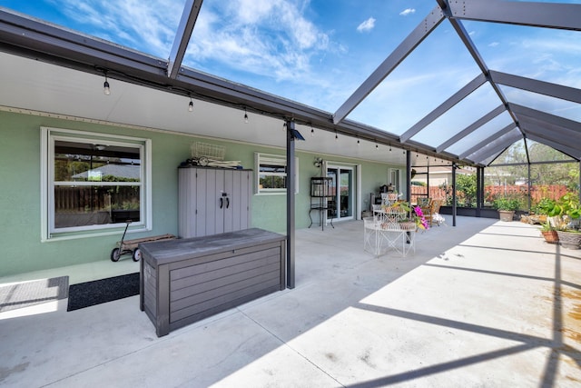 view of patio / terrace featuring glass enclosure