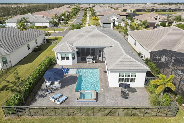 exterior space with a fenced backyard, a tiled roof, a residential view, stucco siding, and a patio area