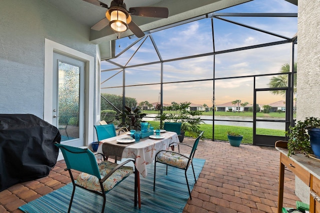 sunroom / solarium with a ceiling fan and a healthy amount of sunlight