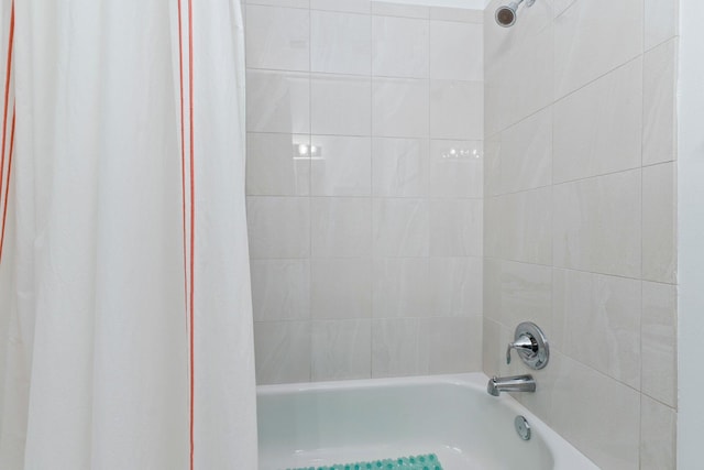 bathroom with shower / bath combo with shower curtain