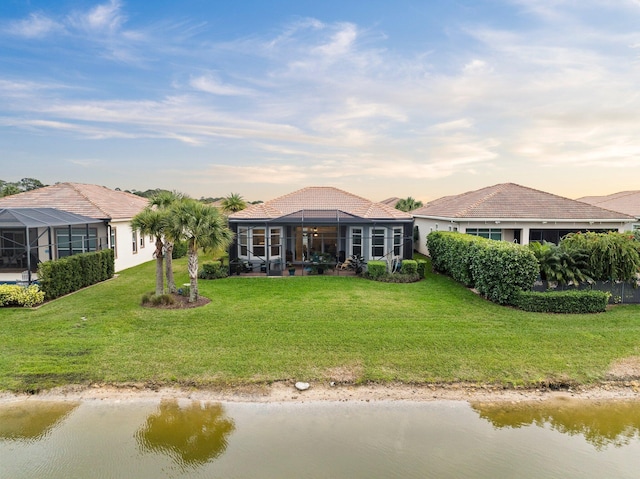 view of front of property with a water view, a lanai, and a front yard