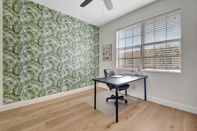 home office with baseboards, light wood-style flooring, and wallpapered walls