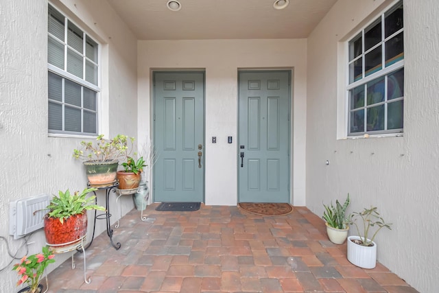 property entrance with stucco siding