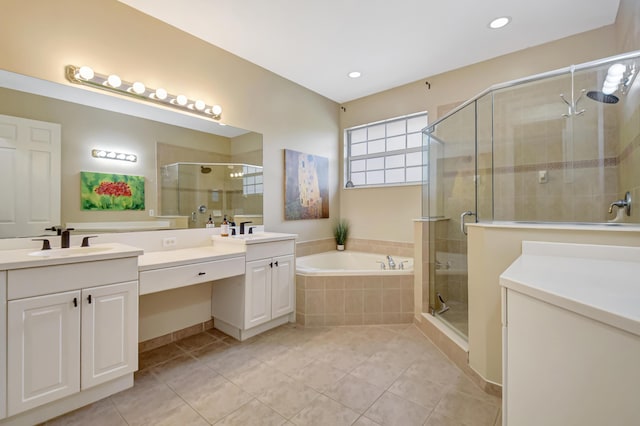 bathroom with a garden tub, a shower stall, tile patterned floors, and vanity