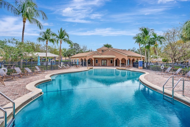 pool featuring a patio area and fence