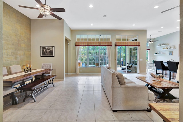 living area with light tile patterned floors, ceiling fan, recessed lighting, and baseboards