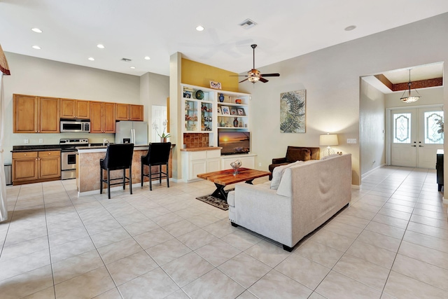 living room featuring light tile patterned floors, french doors, recessed lighting, and baseboards