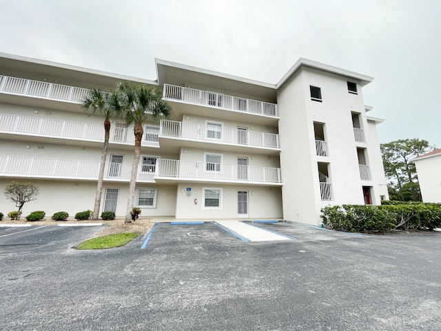 view of building exterior featuring uncovered parking