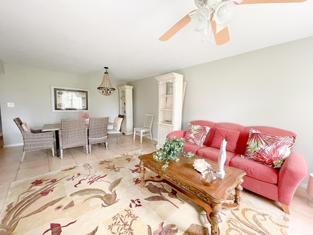 living room featuring light tile patterned floors, baseboards, and a ceiling fan