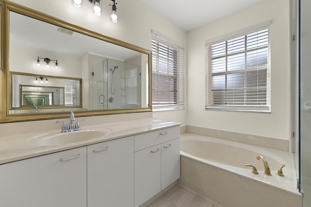 full bathroom with a bath, tile patterned flooring, a shower stall, and vanity